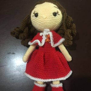 Cute curly hair doll in red dress.